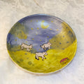 Happy lambs running around tiny plate