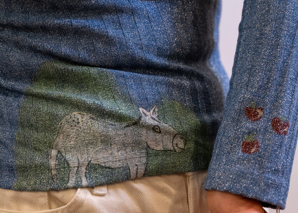 Polo neck baby donkey and its apples