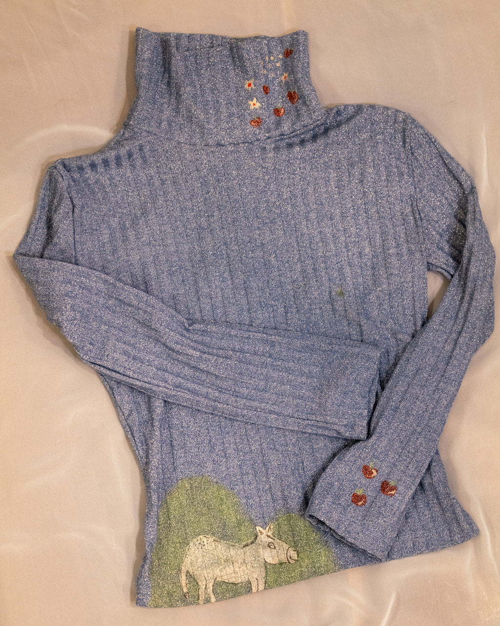 Polo neck baby donkey and its apples