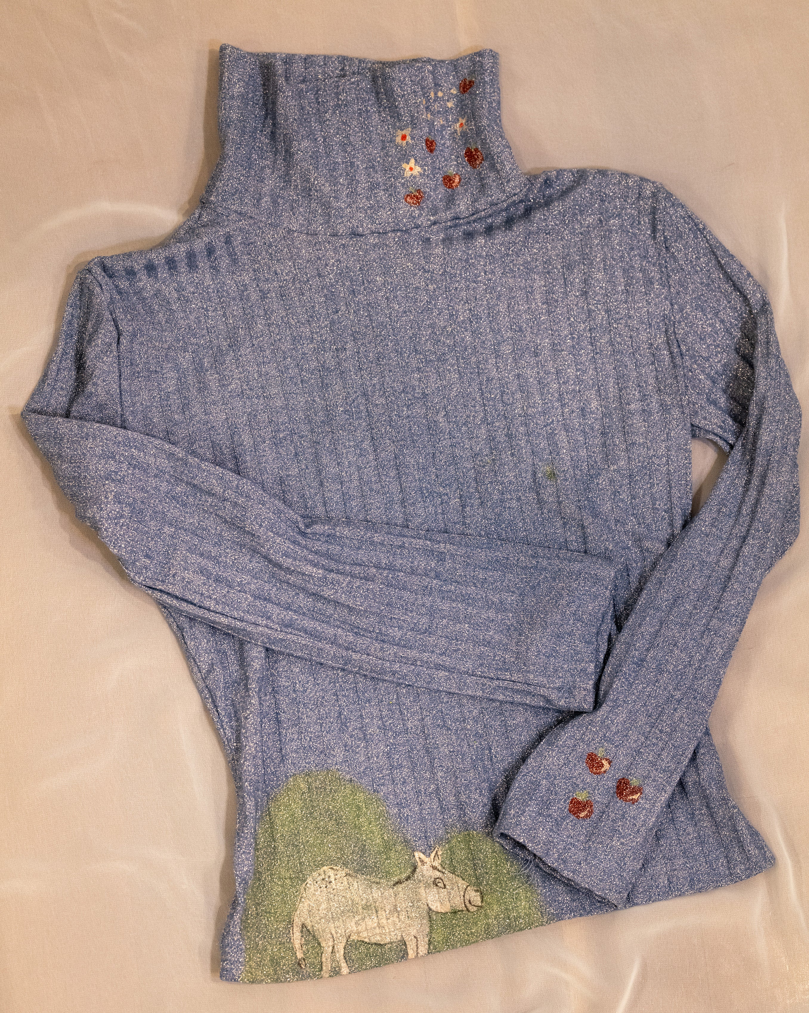 Polo neck baby donkey and its apples